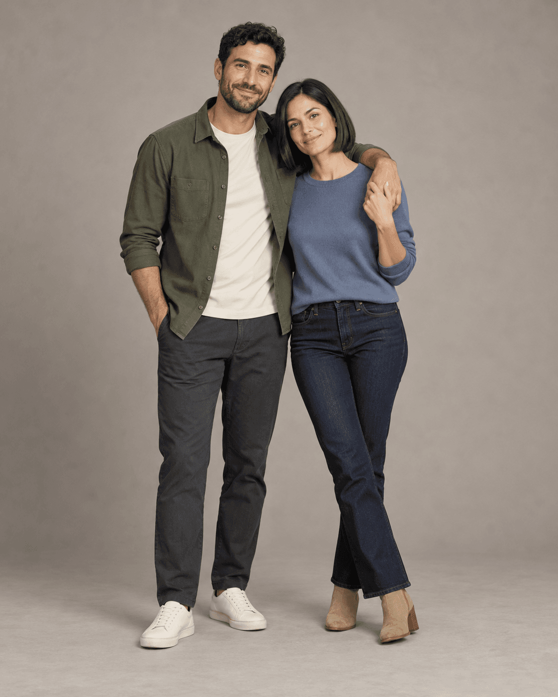 AI-generated full-length studio concept of two fictional adults: Person A wears an olive overshirt and charcoal trousers; Person B wears a muted blue cotton top and dark denim.