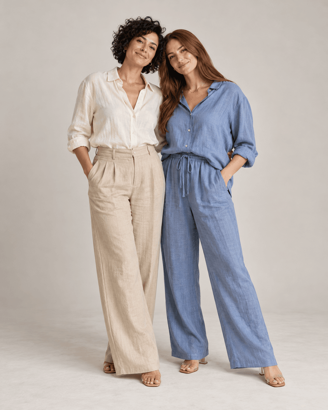AI-generated full-length studio concept of two fictional adults: Person A wears a cream linen-look shirt and sand trousers; Person B wears muted blue relaxed woven separates.